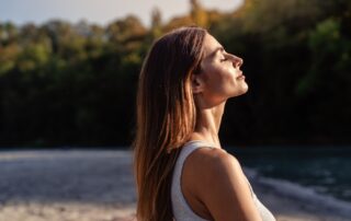 A woman soaking up the sunshine on the beach.