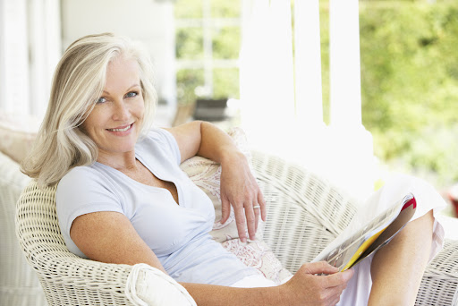 older woman reading a book who has had a neck lift