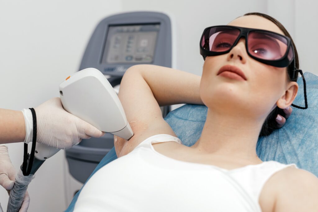 Woman getting laser treatment on arm pits.