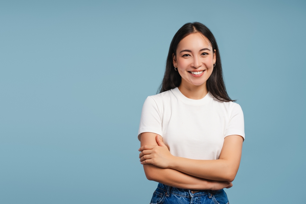 A woman crossing her arms and smiling